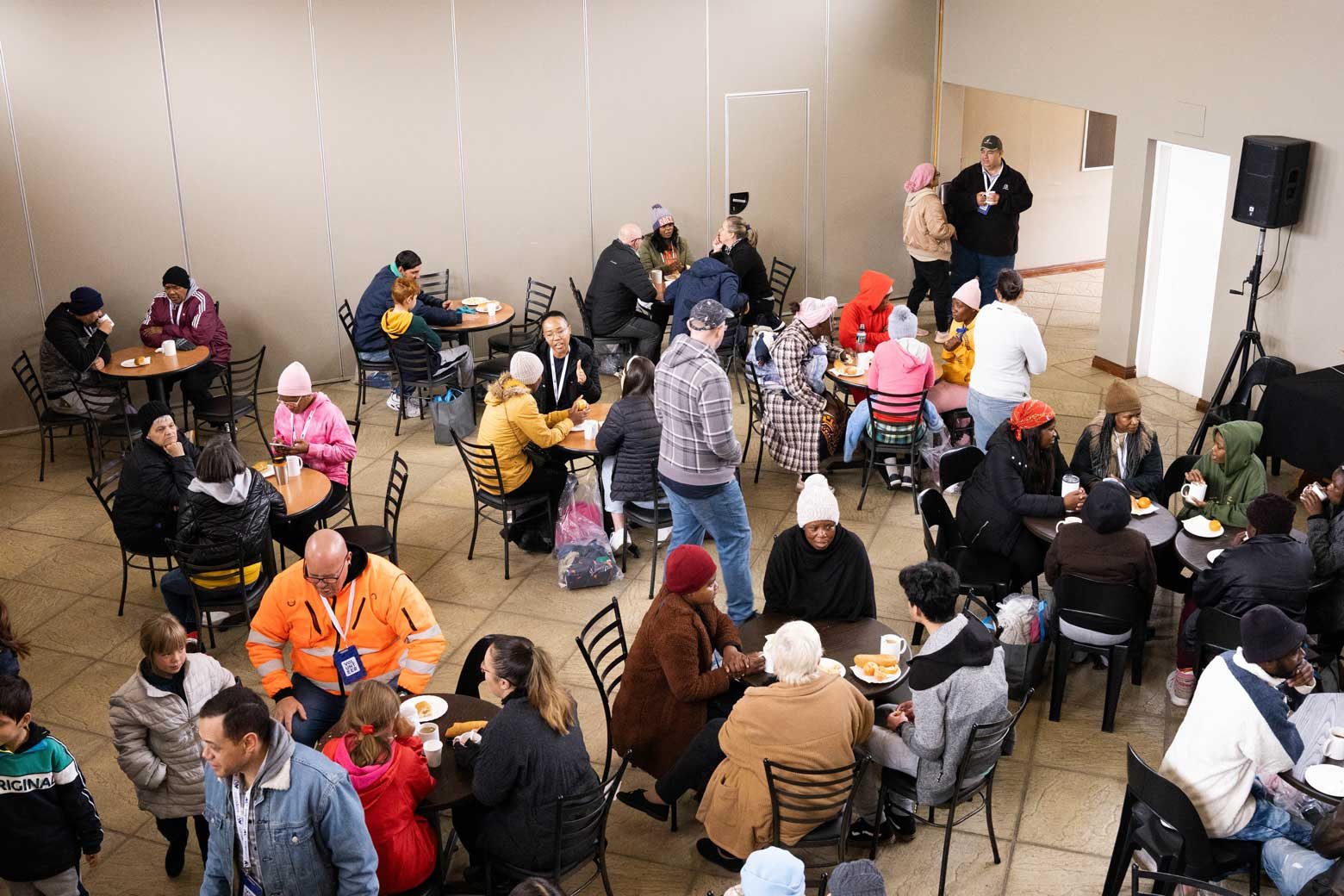 Families seated at tables during a Care Day
