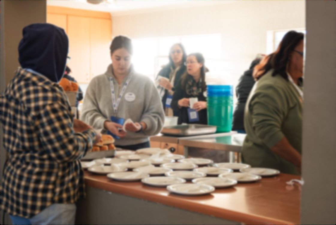 Volunteers serving meals to families at a Liberty Compassion Care Day