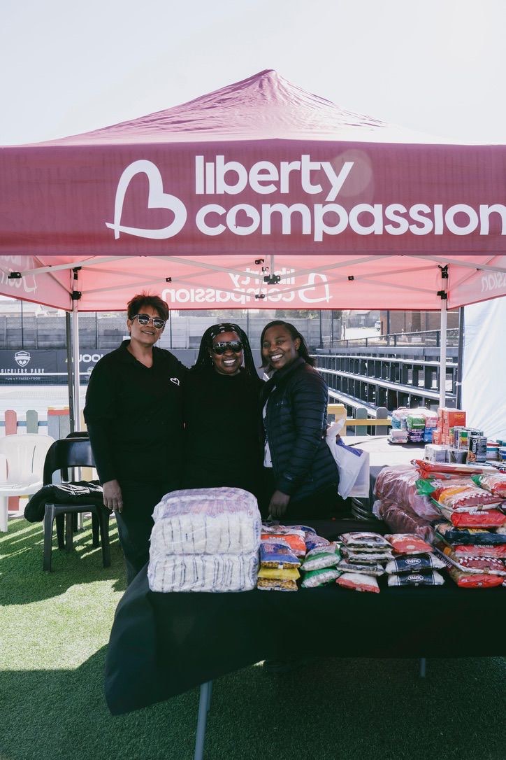 Liberty Compassion team members at the branded stand